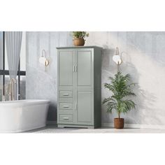 a tall cabinet next to a bathtub in a room with a potted plant