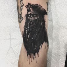 a man's leg with a pirate tattoo on it