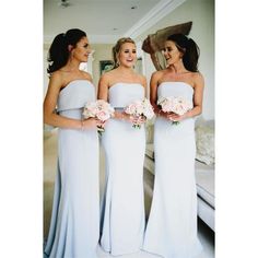 three women in white dresses standing next to each other and holding bouquets with pink flowers