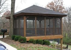 a wooden gazebo sitting in the middle of a park