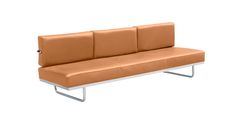 an orange couch sitting on top of a white metal frame with two arms and backrests