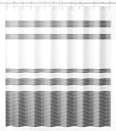 a black and white shower curtain with wavy lines on the bottom, in front of a white background