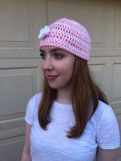 Handmade crochet hat featuring pink and white stripes and a decorative crochet flower. Style is reminiscent of the early 2000s trend and machine washable. Pink Spring Beanie Cap, Casual Pink Beanie For Spring, Pink Cotton Beanie (one Size Fits Most), Pink Cotton Beanie, Pink Cotton Beanie, One Size Fits Most, Cute Pink Crochet Beanie Hat, Cute Pink Crochet Beanie, Spring Yarn Beanie, Knitted Beanie For Spring