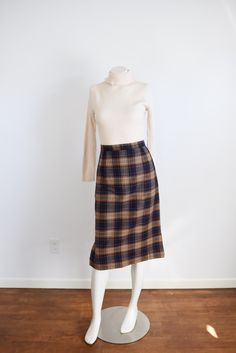 "Description: A navy and brown plaid pencil skirt with back metal zipper and snaps for closure. Unlined.  Measurements of garment, allow space for fit.  Waist: 25.5\" Hips: 38\" Length: 28\" I take my measurements flat, and double for circumference.  Tag: No tag, looks handmade. Fabric: Wool or blend Condition: Excellent Follow along on instagram @lovecharlesvintage" Fitted Plaid Pencil Skirt, Fitted Plaid Pencil Skirt For Work, Fitted Plaid Skirt For Office, Fitted Knee-length Plaid Bottoms, Fall Plaid Pencil Skirt, Plaid Pencil Skirt For Work, 40s Skirt, Pink Wool Coat, Tube Top Outfits