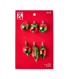 three red and green christmas ornaments on a card