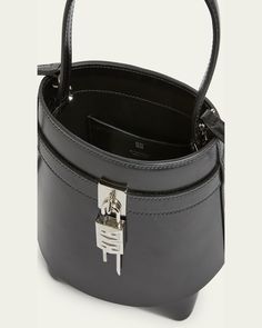 Givenchy "Shark Lock" bucket bag in leather     Features signature logo padlock accent     Flat top handle     Open top     Interior, one slip pocket     Approx. 7.4"H x 7.9"W x 5.7"D    Made in Italy Modern Formal Bucket Bag With Silver-tone Hardware, Formal Satchel Bucket Bag With Metal Hardware, Designer Formal Bucket Bag With Palladium Hardware, Formal Top Handle Bucket Bag With Metal Hardware, Formal Tote Shoulder Bag With Lock, Luxury Bucket Bag With Silver-tone Hardware For Formal Occasions, Designer Top Handle Bucket Bag With Metal Hardware, Formal Rectangular Bucket Bag With Palladium Hardware, Formal Bucket Bag With Metal Hardware And Tote Shape