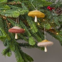 three ornaments hanging from a christmas tree