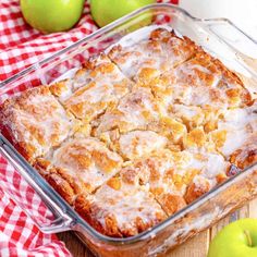 a casserole dish with apples in the background