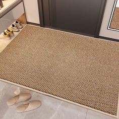 a pair of shoes sitting on the floor in front of a door with a rug