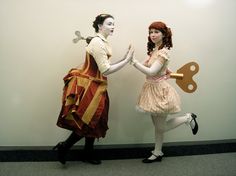 two women dressed in costumes standing next to each other