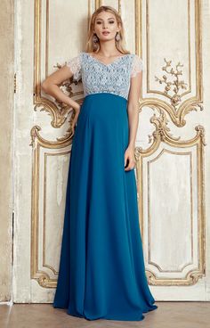 Our Eleanor full length blue-green maternity gown is a magical dress for any occasion. From the luxurious lace bodice in pale aqua tones to the dramatic draping panelled skirt with concealed back zip in Kingfisher blue, it is a truly exquisite dress to wear. For a hint of vintage drama, the capped sleeves are finished with pretty eyelash details and soft crossover shoulders with a shallow v neckline both front and back, darted below the bust for a neat fit. Pair with crystals, diamonds or pearls Fitted Lace Bodice Maxi Gown, Lace Bodice Maxi Gown, Blue Lace Bodice Gown For Wedding, Blue Lace Gown With Sweep Train, Blue Lace Bodice Ball Gown, Blue Lace Evening Dress With Lace Bodice, Blue Ball Gown With Lace Bodice, Maternity Wedding Dress With Lace Trim And Maxi Length, Floor-length Gown With Lace Sleeves And Fitted Bodice