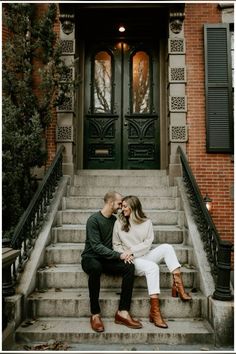 a man and woman sitting on steps in front of a building with their eyes close to each other