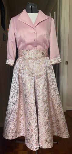 This custom designed wedding ensemble includes a satin brocade skirt in rose and rose gold. The coordinating blouse is made of matte satin. This fits size 10 with a 37 inch bust and a 33 inch waist. The skirt length is tea length at 35 inches. Buttons on the blouse are pink pearl. Skirt closure is side zipper with hooks at waist. Tea-length Satin Wedding Dress, Satin A-line Mother Of The Bride Dress For Wedding, Elegant Pink Evening Skirt, Elegant Pink Mother Of The Bride Dress For Wedding, Elegant Pink Wedding Sets, Elegant Pink Skirt For Bridesmaids, Feminine Satin Skirt For Formal Occasions, Formal Feminine Satin Skirt, Feminine Formal Satin Skirt