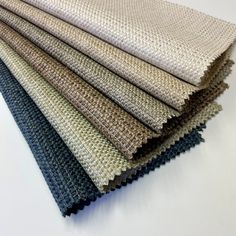 several different colors of fabric on a white surface