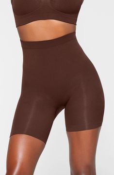 Sculpt your body's natural shape with shaping shorts that hit just above the knee with a whisper-soft and seamless design from Kim Kardashian's SKIMS. Reflecting the brand's passion for highly technical shapewear solutions for every body, this staple piece smoothes your upper legs while lifting your butt and comes in different shades to complement your skin tone. 5" regular inseam Cotton-lined gusset 82% nylon, 18% elastane Machine wash, tumble dry Made in Turkey Compressive Shapewear Shorts, Elastane Shapewear Short Length, Seamless Compression Shapewear Mid-thigh Length, Seamless Compression Shapewear, Mid-thigh Length, Seamless Shaping Shapewear Short Length, Seamless Shaping Shapewear In Short Length, Seamless Mid-thigh Length Shapewear, Seamless Short Length Shaping Shapewear, Shaping Shapewear Seamless Shorts