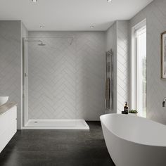 a bathroom with a tub, sink and large mirror on the wall next to it