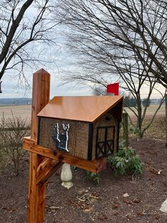 a mailbox in the shape of a horse stable