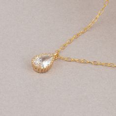 The Delicate CZ Drop Necklace features a high-quality cubic zirconia pendant in a teardrop format on a delicate 14K gold-filled chain. This tiny diamond pendant necklace is perfect for a bridesmaid necklace gift or for that special occasion. PRODUCT DETAILS: The stone is 6mm. Zirconia Stone in a 14k goldfilled setting MATERIALS: 14K Gold Filled 14K Gold Filled jewelry is not the same as gold-plated jewelry. It contains 5% of solid gold and is done by a process of heat bonding. The layer of gold Dainty Cubic Zirconia Drop Necklace, Elegant Gold Solitaire Teardrop Necklace, Dainty Cubic Zirconia Teardrop Necklace, Dainty Teardrop Cubic Zirconia Drop Necklace, Delicate Gold Teardrop Solitaire Necklace, Gold Cubic Zirconia Drop Necklace Gift, Gold Solitaire Drop Necklace For Wedding, Gold Teardrop Solitaire Necklace For Wedding, Gold Solitaire Necklace With Teardrop Pendant For Wedding