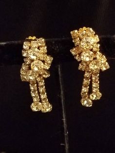 This is a Wonderful KRAMER of N.Y. vintage signed gold tone Rhinestone earrings. condition is very good vintage condition Vintage Yellow Gold Clip-on Earrings For Party, Vintage Gold Clip-on Earrings For Vintage Events, Gold Vintage Clip-on Earrings For Vintage Events, Gold Vintage Clip-on Earrings, Vintage Gold Clip-on Earrings With Rhinestones, Vintage Gold Crystal Earrings With Rhinestones, Gold Costume Jewelry Earrings For Anniversary, Vintage Gold Clip-on Earrings For Party, Vintage Earrings With Sparkling Stones