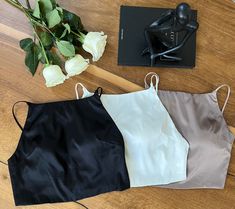 Introducing our minimalist and elegant crop cami seamless bra top with adjustable straps. This item is made with 91% mulberry silk and 9% spandex, providing a soft, comfortable, breathable, and stretchy feel. It's versatile and perfect for a wide range of occasions for day & night and lounging in. You will look effortlessly beautiful wearing this on its own or with a cardigan/light jacket.  Colors:  Silky black/Pearl White (No longer available)/Mocha The photos and video were taken under natural light with no filter. Sizes: S: 79 - 87 M: 86 - 94 Washing instruction: - Handwash in cold water  - Hang dry and avoid direct sunlight  - Low temp iron - No tumble dry Chic Crop Top Camisole With Built-in Bra, Solid Crop Top Camisole With Built-in Bra, Chic Seamless Halter Camisole Top, Chic Seamless Camisole Halter Top, Elegant Stretch Crop Top With Built-in Bra, Elegant Tank Crop Top, Elegant Tank Crop Top For Night Out, Chic Seamless Halter Top With Tank Straps, Bra Friendly Halter Camisole Top For Summer