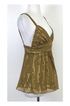 The Milly collection epitomizes bold & advanced contemporary fashion with a graceful edge. Milly designs can be found around the globe and have grown increasingly popular over the years for their luxurious fabrics and creative style. This gold silk spaghetti strap top is light & silky. Breathable fabric keeps you cool during warmer days. Wear it with your favorite shorts or skirt. Size 6 Body 85% Silk 15% Metallic Lining 100% Polyester Concealed back zip Plunge neckline Spaghetti strap Shoulder Designer Fitted Gold Top, Gold Silk V-neck Top, Gold Silk Top For Spring, Spring Gold Silk Top, Gold Silk Tops For Spring, Chic Gold Tops For Festive Occasions, Chic Gold Festive Tops, Elegant Summer Festive Tops, Elegant Festive Summer Tops