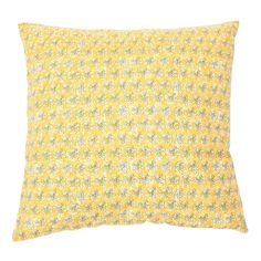 a yellow and white pillow with small flowers on the front, against a white background