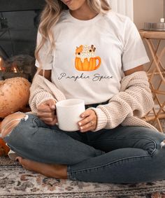 A cozy Pumpkin Spice Tee for everyone, who is a Pumpkin Spice Lover like me!- xoxo Nikki  PRODUCTION TIME: 1-3 days (Usually 2 days)  SHIPPING TIME: 2-5 days (Usually 3 days)  PRODUCT DESCRIPTION:        Bella Canvas Unisex T-Shirt        Super soft cotton and excellent quality print makes        100% Soft cotton (fiber content may vary for different colors)        Light fabric (4.2 oz/yd2  (142 g/m2))        Runs true size        Our Relaxed Fit Tee (Bella+ Canvas style 3001) is a unisex style Cozy Cotton T-shirt For Loungewear, Cozy Crew Neck T-shirt For Loungewear, Cozy White Graphic Print T-shirt, Cozy Cotton T-shirt With Graphic Print, Cozy Letter Print T-shirt For Loungewear, Cozy Relaxed Fit T-shirt With Graphic Print, Fall White T-shirt For Loungewear, Cozy T-shirt With Letter Print For Loungewear, Cozy White Tops With Graphic Print