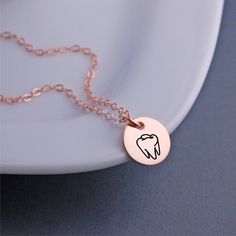 A 12mm (1/2 inch) disc is engraved with a tooth outline. Metals available include 14k rose gold filled, 14k gold filled and stainless steel pendant with sterling silver filled chain. Lengths available include 16, 18 or 20 inches. **ALL charms are optional! (shown with 1 added initial charm). Choose from initials, Swarovski crystal birthstones or other symbols. Rose Gold Charm Necklace With Round Pendant, Minimalist Rose Gold Hand Stamped Charm Necklaces, Rose Gold Hypoallergenic Necklace For Everyday, Minimalist Hand Stamped Rose Gold Charm Necklace, Minimalist Rose Gold Hand Stamped Charm Necklace, Rose Gold Hypoallergenic Necklaces For Personalized Gifts, Hypoallergenic Rose Gold Necklaces For Personalized Gifts, Hypoallergenic Rose Gold Sterling Silver Charm Necklace, Rose Gold Hypoallergenic Necklace For Personalized Gifts