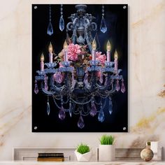 a chandelier with pink flowers and candles on it