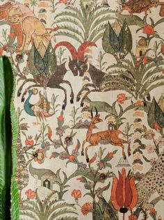 the wallpaper is decorated with animals and plants in an old fashion style, as well as green leaves