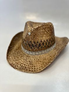 Add some western flair to your child's or your own wardrobe with our Cowgirl Hat! Made from high-quality woven straw, this hat is perfect for those who want to embrace the stylish and trendy cowgirl look. Featuring a classic western style with a wide brim that provides ample shade and protection from the sun, our Cowgirl Hat comes in a pretty tan color with rhinestone detailing that adds a touch of glamour to your outfit. This hat is available in both child and adult sizes, making it perfect for all ages. Our Cowgirl Hat is perfect for any occasion, whether it's dress-up, rodeos, western-themed parties, or even everyday wear. With its stylish design and attention to detail, this hat will have you looking and feeling like a true cowgirl. Overall, our Cowgirl Hat is a must-have for anyone wh Country Style Rhinestone Hats For Rodeo, Western Adjustable Hats With Rhinestones, Look Cowgirl, Cowgirl Hats Western, Boho Chic Hats, Pretty Tan, Cowgirl Look, Cowgirl Accessories, Summer Hats Beach