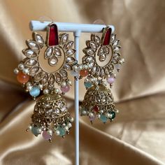 The most stunning multi colour crystal drop earrings, lightweight and adorned with zircon crystals and beautiful bead work. Measurements 2.5 inch Width x 1.5 inch length Perfect for any glam occasion.  Ready to ship! Elegant Multicolor Jeweled Crystal Earrings, Glamorous Multicolor Wedding Jewelry, Elegant Multicolor Jhumkas For Celebration, Elegant Multicolor Jhumkas For Festive Occasions, Elegant Multicolor Jeweled Chandelier Earrings, Multicolor Jeweled Metal Earrings, Fusion Dangle Earrings For Party, Fusion Style Dangle Earrings For Party, Festive Metal Jeweled Earrings