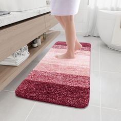 a person standing on a rug in a bathroom