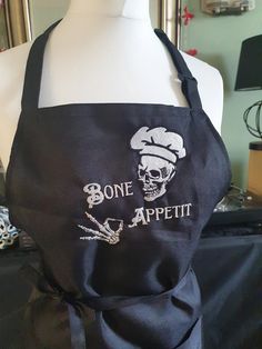 a black apron with the words bone appeti written on it