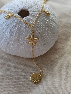 This is a Y shape gorgeous necklace for all beach lovers to express their love for ocean seashells! Dainty dangly cowrie shells, marine animals and starfish are such a site! Great gift for surfers, beach girls to scuba and freedivers to express their love for marine life! Such a flattering beach style to mix and match with other Kikita Jewelry pieces.  *18k gold-plated * gold-plated - length: 18 Inches +  *Adjustable length  *Lobster clasp closure   All Products are inspected for Quality 🤍To ex Gold Ocean Jewelry, Beach Girl Jewelry, Beach Accessories Jewelry, Gold Beach Jewelry, Summer Necklace Beach, Ocean Accessories, Summer Jewelry Beach, Beach Jewellery, Starfish Jewelry