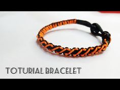 an orange and black braided bracelet on a white background with the words totural bracelet