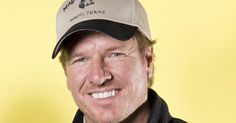 a man wearing a hat and smiling at the camera with a yellow background behind him