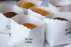 six white paper bags filled with food on top of a table