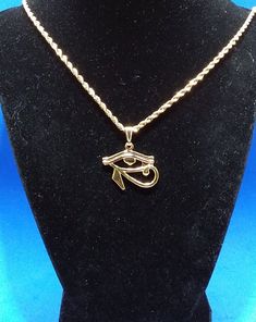 Gold 24 kt Eye of Horus Charm Necklace ☆  Wedjat Eye | Eye of Ra ☆  Eye of Horus Necklace | African Jewelry ☆  For Him or Her | Protection Amulet☆  Golden Eye of Horus measures 1.25 inches wide     by 1 inch high☆ Strung on a gold snap-on bale☆ An 18 inch long 2 mm wide gold rope chain     with lobster clasp is also included.☆ FREE Eco-Packaging in a Jewelry Gift Box & Gift Bag!☆ Ships same day as order to USA.☆ A FREE GIFT is included with every order!☆ FREE USA Shipping on orders of $35 or Gold Ankh Shaped Metal Jewelry, Gold Plated Spiritual Charm Necklaces, Gold Ankh Metal Jewelry, Gold Spiritual Charm Necklace, Metal Rope Chain Jewelry For Gifts, Rope Chain Jewelry Gift, Metal Rope Chain Jewelry Gift, Handmade Gold Ankh Necklace, Handmade Ankh Gold Necklace