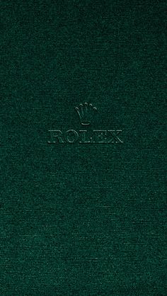 a green book with the word rolex written on it and a crown in the middle