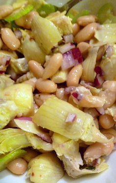 a white bowl filled with salad and beans