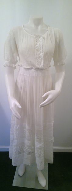 Edwardian lawn dress white cotton gauze 1910's lace insets puff sleeves gathered waist tiered skirt theater costume historical fashion by Vintageroyaleny on Etsy https://www.etsy.com/listing/673091211/edwardian-lawn-dress-white-cotton-gauze White Fitted Victorian Dress For Summer, White Fitted Victorian Summer Dress, Summer Victorian Dress With Empire Waist, White Victorian Dress For Spring Formal, Fitted White Victorian Dress, Elegant Victorian Dress For Summer, White Victorian Wedding Dress For Summer, White Regency Style Vintage Dress For Formal Occasions, White Victorian Dress With Lace Trim