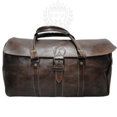 a brown leather duffel bag sitting on top of a white background with an emblem above it