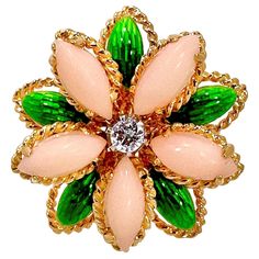 This lovely, Mid-20th Century 18K yellow gold Italian flower motif ring feels beautifully organic. The diamond in the center is surrounded by angel skin coral petals and transparent green enamel leaves. The diamond weighs approximately .17ct of G color and VS2 clarity. Measures 1 inch in diameter. It is stamped 18K Italy on the inside. Ring is a size 7 3/4. Gross weight 11.10 grams. Italian Flowers, Angel Skin, Coral Jewelry, Flower Motif, Enamel Flower, Diamond Flower, Fashion Ring, Green Enamel, Gold Flowers