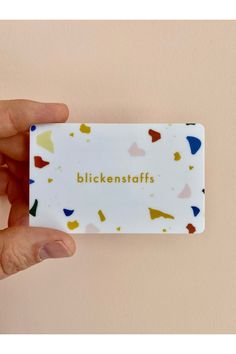 a person holding up a business card with the words biikenstaffs printed on it