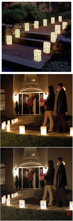 people walking in front of a house at night with paper lanterns floating from the roof