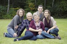 a group of people that are sitting in the grass