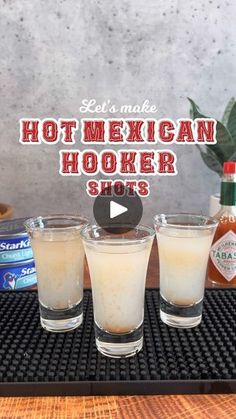 three shot glasses sitting next to each other on top of a tray with hot mexican hooker shots