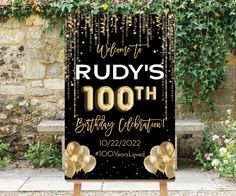 a black and gold birthday sign with balloons