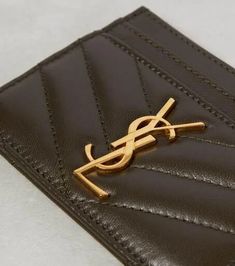 Made from matelassé leather, the Cassandre card holder is completed with signature monogram in gold. One of the most famous symbols in fashion, the YSL monogram consists of the intertwined initials of Saint Laurent's founder..Internal details: leather lining.Material: leather.Comes with dust bag.Comes with a box.Made in Italy.Height 7,5cm-3'.Width 10,5cm-4' Classic Gold Wallet With Logo Plaque, Luxury Business Wallets With Gold-tone Logo Plaque, Luxury Business Wallet With Gold-tone Logo, Elegant Leather Card Holder With Logo, Luxury Gold Wallets With Logo Plaque, Formal Gold Wallets With Logo Plaque, Elegant Formal Wallets With Logo, Designer Business Card Holder With Logo, Designer Logo Card Holder For Business